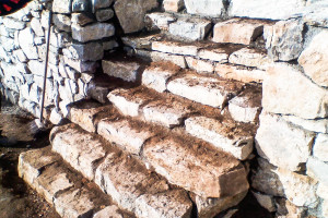 Natural stone steps to the upper terrace.